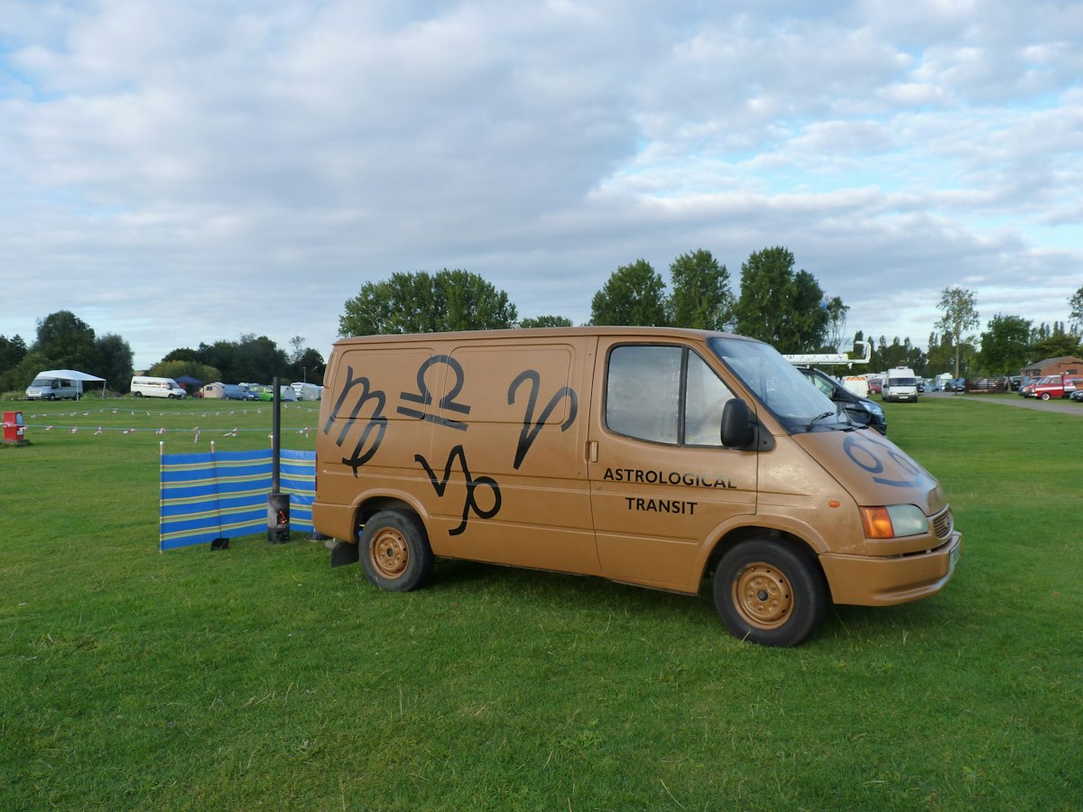 Stand-in photo: a grooming van parked on a quiet green street